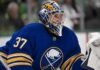 Connor Hellebuyck wearing a Buffalo Sabres jersey and goalie mask amid NHL trade rumours involving the Winnipeg Jet
