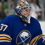 Connor Hellebuyck wearing a Buffalo Sabres jersey and goalie mask amid NHL trade rumours involving the Winnipeg Jet