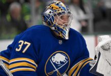 Connor Hellebuyck wearing a Buffalo Sabres jersey and goalie mask amid NHL trade rumours involving the Winnipeg Jet
