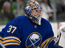 Connor Hellebuyck wearing a Buffalo Sabres jersey and goalie mask amid NHL trade rumours involving the Winnipeg Jet