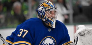 Connor Hellebuyck wearing a Buffalo Sabres jersey and goalie mask amid NHL trade rumours involving the Winnipeg Jet