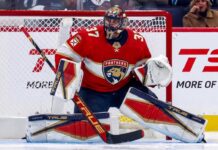 Connor Hellebuyck Trade Rumors: Could the Jets Star Join the Florida Panthers? Winnipeg Jets goaltender Connor Hellebuyck in his butterfly stance during an NHL game, wearing his signature blue and white goalie gear. The image captures him focused on the action in front of the net.