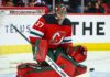 Will the New Jersey Devils Trade for Winnipeg Jets Goalie Connor Hellebuyck? Connor Hellebuyck (No. 37) wearing a custom New Jersey Devils home jersey, mask, and goaltending pads, posed in a butterfly save position during an NHL hockey game, a visualization of potential trade rumors.