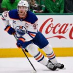 Connor McDavid skating for the Edmonton Oilers with a Coca-Cola board ad in a 2026-27 fantasy hockey point projections preview