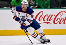 Connor McDavid skating for the Edmonton Oilers with a Coca-Cola board ad in a 2026-27 fantasy hockey point projections preview