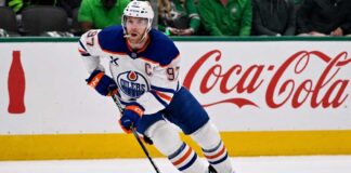Connor McDavid skating for the Edmonton Oilers with a Coca-Cola board ad in a 2026-27 fantasy hockey point projections preview