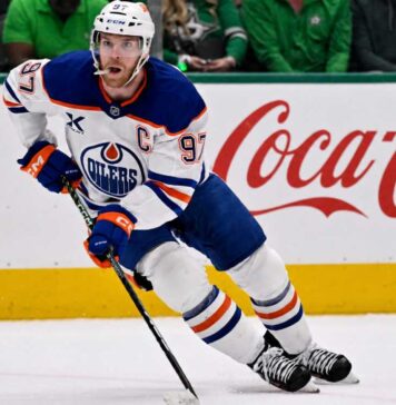 Connor McDavid skating for the Edmonton Oilers with a Coca-Cola board ad in a 2026-27 fantasy hockey point projections preview