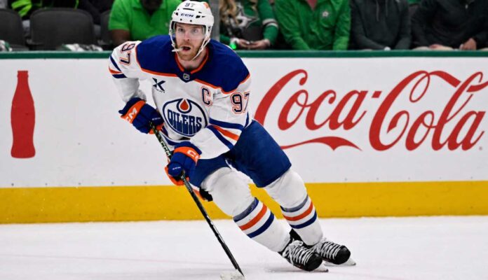 Connor McDavid skating for the Edmonton Oilers with a Coca-Cola board ad in a 2026-27 fantasy hockey point projections preview