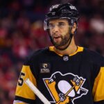 Darnell Nurse Trade Rumors: Oilers Defenseman Linked to Penguins Medium shot of NHL defenseman Darnell Nurse visualized in a Pittsburgh Penguins black and gold home jersey amidst trade rumors linking him away from the Edmonton Oilers.