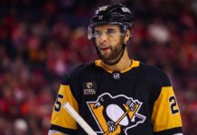 Medium shot of NHL defenseman Darnell Nurse visualized in a Pittsburgh Penguins black and gold home jersey amidst trade rumors linking him away from the Edmonton Oilers.