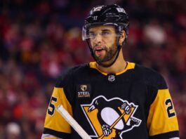 Medium shot of NHL defenseman Darnell Nurse visualized in a Pittsburgh Penguins black and gold home jersey amidst trade rumors linking him away from the Edmonton Oilers.
