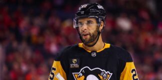 Medium shot of NHL defenseman Darnell Nurse visualized in a Pittsburgh Penguins black and gold home jersey amidst trade rumors linking him away from the Edmonton Oilers.