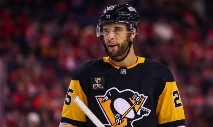 darnell-nurse-edmonton-oilers-pittsburgh-penguins-trade-rumor Medium shot of NHL defenseman Darnell Nurse visualized in a Pittsburgh Penguins black and gold home jersey amidst trade rumors linking him away from the Edmonton Oilers.