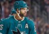 Darnell Nurse wearing a San Jose Sharks jersey and helmet amid Edmonton Oilers trade rumors linking him to San Jose
