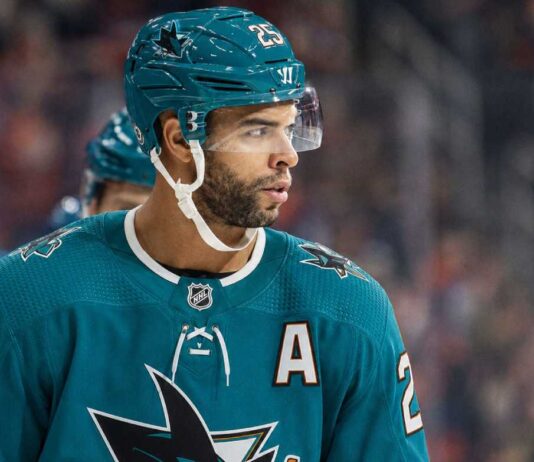 Darnell Nurse wearing a San Jose Sharks jersey and helmet amid Edmonton Oilers trade rumors linking him to San Jose