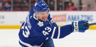 Toronto Maple Leafs defenseman Darren Raddysh windup up for a shot on goal.