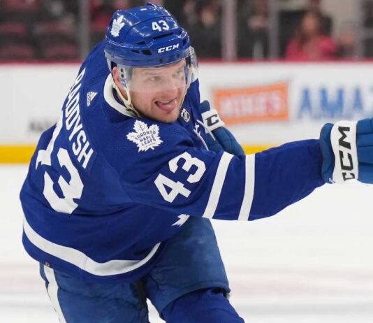 Toronto Maple Leafs Acquire Darren Raddysh in Blockbuster Sign-and-Trade Toronto Maple Leafs defenseman Darren Raddysh windup up for a shot on goal.