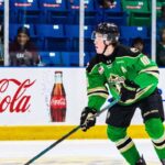 Daxon Rudolph: Why the Florida Panthers Should Draft Him #9 in 2026 Daxon Rudolph, 2026 NHL Draft prospect, skating with the puck in a Prince Albert Raiders green jersey (number 10) during a WHL game, showcasing junior hockey stats for Florida Panthers scouts.