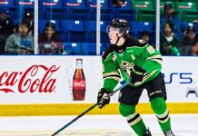 Daxon Rudolph: Why the Florida Panthers Should Draft Him #9 in 2026 Daxon Rudolph, 2026 NHL Draft prospect, skating with the puck in a Prince Albert Raiders green jersey (number 10) during a WHL game, showcasing junior hockey stats for Florida Panthers scouts.