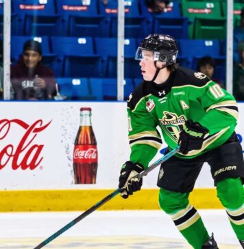 Daxon Rudolph: Why the Florida Panthers Should Draft Him #9 in 2026 Daxon Rudolph, 2026 NHL Draft prospect, skating with the puck in a Prince Albert Raiders green jersey (number 10) during a WHL game, showcasing junior hockey stats for Florida Panthers scouts.