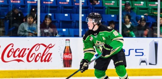 Daxon Rudolph: Why the Florida Panthers Should Draft Him #9 in 2026 Daxon Rudolph, 2026 NHL Draft prospect, skating with the puck in a Prince Albert Raiders green jersey (number 10) during a WHL game, showcasing junior hockey stats for Florida Panthers scouts.