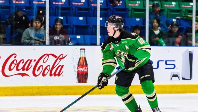 daxon-rudolph-florida-panthers-draft-prospect Daxon Rudolph, 2026 NHL Draft prospect, skating with the puck in a Prince Albert Raiders green jersey (number 10) during a WHL game, showcasing junior hockey stats for Florida Panthers scouts.