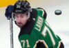 Dylan Larkin Trade Rumors: Detroit Red Wings Star Linked to Dallas Stars Description: A photorealistic image of Detroit Red Wings captain Dylan Larkin in a Victory Green Dallas Stars home hockey jersey (number 71) and black helmet, holding a hockey stick. This image was generated to visualize trade rumors linking Larkin to Dallas.