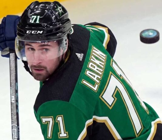 Dylan Larkin Trade Rumors: Detroit Red Wings Star Linked to Dallas Stars Description: A photorealistic image of Detroit Red Wings captain Dylan Larkin in a Victory Green Dallas Stars home hockey jersey (number 71) and black helmet, holding a hockey stick. This image was generated to visualize trade rumors linking Larkin to Dallas.