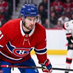 Dylan Larkin Trade Rumors: Will the Montreal Canadiens Strike a Deal? Montreal Canadiens forward Dylan Larkin (number 71) is captured in a red home jersey, skating with the puck in a high-quality NHL action photograph. The photo highlights his focus and skill, a key figure in recent trade speculation.