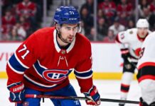 Dylan Larkin Trade Rumors: Will the Montreal Canadiens Strike a Deal? Montreal Canadiens forward Dylan Larkin (number 71) is captured in a red home jersey, skating with the puck in a high-quality NHL action photograph. The photo highlights his focus and skill, a key figure in recent trade speculation.