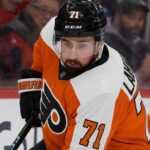 Dylan Larkin Trade Rumors: Will the Detroit Red Wings Deal With the Philadelphia Flyers? Detroit Red Wings captain Dylan Larkin wearing a Philadelphia Flyers home uniform and orange helmet in a hockey pose, illustrating recent NHL trade rumors linking him to Philly.