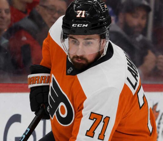 Dylan Larkin Trade Rumors: Will the Detroit Red Wings Deal With the Philadelphia Flyers? Detroit Red Wings captain Dylan Larkin wearing a Philadelphia Flyers home uniform and orange helmet in a hockey pose, illustrating recent NHL trade rumors linking him to Philly.