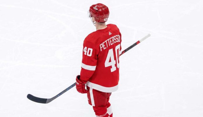 elias-pettersson-vancouver-canucks-detroit-red-wings-trade-rumor A composite graphic image of Vancouver Canucks center Elias Pettersson in a custom Detroit Red Wings #40 jersey.