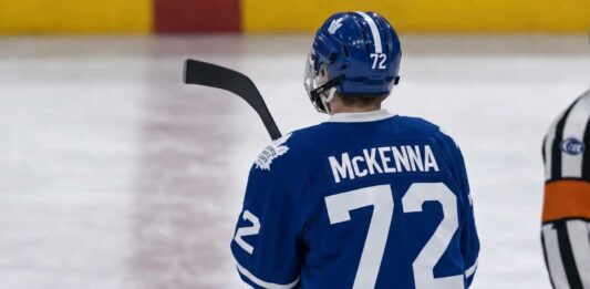 Gavin McKenna Toronto Maple Leafs: 2026 NHL Draft #1 Pick Analysis Gavin McKenna wearing a blue Toronto Maple Leafs home jersey with number 72 and the numbered blue helmet, seen from behind on an ice rink, viewed as the projected #1 overall pick for the 2026 NHL Draft.