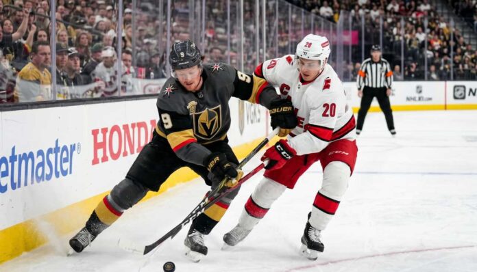 hurricanes-golden-knights-game-3-stanley-cup Jack Eichel of the Vegas Golden Knights and Sebastian Aho of the Carolina Hurricanes battling for the puck along the boards during Game 3 of the 2026 Stanley Cup Final.