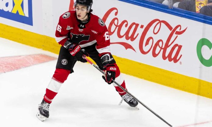 Maddox Dagenais #16 of the Quebec Remparts QMJHL, a 6'4" center, skating with the puck. Background rink boards with large Coca-Cola logo. Image from an article on Utah Mammoth NHL Draft pick analysis.