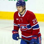 An imagined photo of hockey player Matthew Knies in a Montreal Canadiens home jersey on the ice.