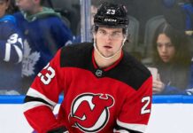 New Jersey Devils Trade Rumors: Could They Land Matthew Knies? A close-up photo of hockey player Matthew Knies wearing a red New Jersey Devils home jersey, number 23, illustrative of the blockbuster trade rumor discussed in the article regarding a potential move from the Toronto Maple Leafs.