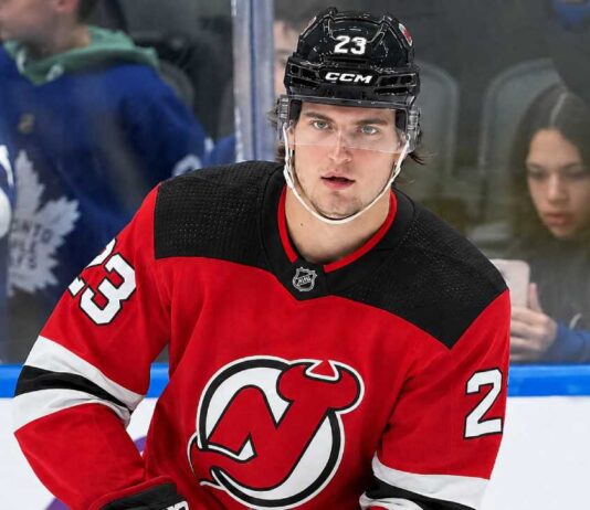 New Jersey Devils Trade Rumors: Could They Land Matthew Knies? A close-up photo of hockey player Matthew Knies wearing a red New Jersey Devils home jersey, number 23, illustrative of the blockbuster trade rumor discussed in the article regarding a potential move from the Toronto Maple Leafs.