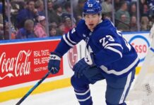 Matthew Knies #23 of the Toronto Maple Leafs skating during an NHL game, surrounded by NHL trade rumors.