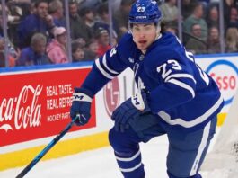 Toronto Maple Leafs Trade Rumors: Will Matthew Knies Be Moved? Matthew Knies #23 of the Toronto Maple Leafs skating during an NHL game, surrounded by NHL trade rumors.
