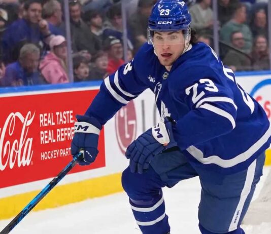 Matthew Knies #23 of the Toronto Maple Leafs skating during an NHL game, surrounded by NHL trade rumors.