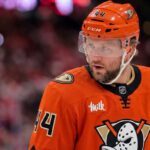 Close-up photo of Toronto Maple Leafs defenseman Morgan Rielly (#44) visualized in an Anaheim Ducks uniform looking thoughtfully during an NHL hockey game.