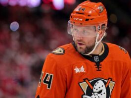 Close-up photo of Toronto Maple Leafs defenseman Morgan Rielly (#44) visualized in an Anaheim Ducks uniform looking thoughtfully during an NHL hockey game.