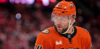 Morgan Rielly Trade Rumors: Why Anaheim Ducks Are the Best Fit Close-up photo of Toronto Maple Leafs defenseman Morgan Rielly (#44) visualized in an Anaheim Ducks uniform looking thoughtfully during an NHL hockey game.