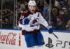 Nathan MacKinnon Point Projections 2026-27: Goals, Assists and Fantasy Outlook Nathan MacKinnon point projections 2026-27 fantasy hockey outlook with Colorado Avalanche star celebrating beside Coca-Cola and PS5 board ads