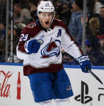 Nathan MacKinnon point projections 2026-27 fantasy hockey outlook with Colorado Avalanche star celebrating beside Coca-Cola and PS5 board ads