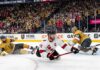 Latest NHL News and NHL Scores: Stanley Cup Final Game 4 Recap Jordan Staal, wearing number 11 and a "C" on his white away jersey, falling to the ice while scoring a diving backhand goal with his Bauer stick, against the Vegas Golden Knights in Game 4 of the 2026 Stanley Cup Final. He is sliding towards the right on the ice, and the puck is visibly entering the net on the far right of the photo.