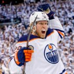Patrik Laine Free Agency: 4 Teams Linked to Pending NHL UFA Conceptual action photo of NHL player Patrik Laine celebrating wildly in an Edmonton Oilers white away jersey and helmet, illustrating potential Free Agency landing spots for the pending UFA.