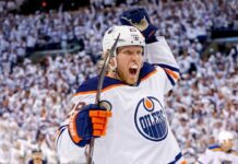 Patrik Laine Free Agency: 4 Teams Linked to Pending NHL UFA Conceptual action photo of NHL player Patrik Laine celebrating wildly in an Edmonton Oilers white away jersey and helmet, illustrating potential Free Agency landing spots for the pending UFA.